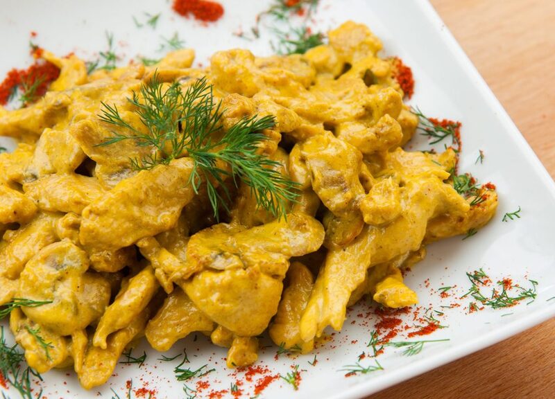 Chicken with curry sauce, salad, and pasta